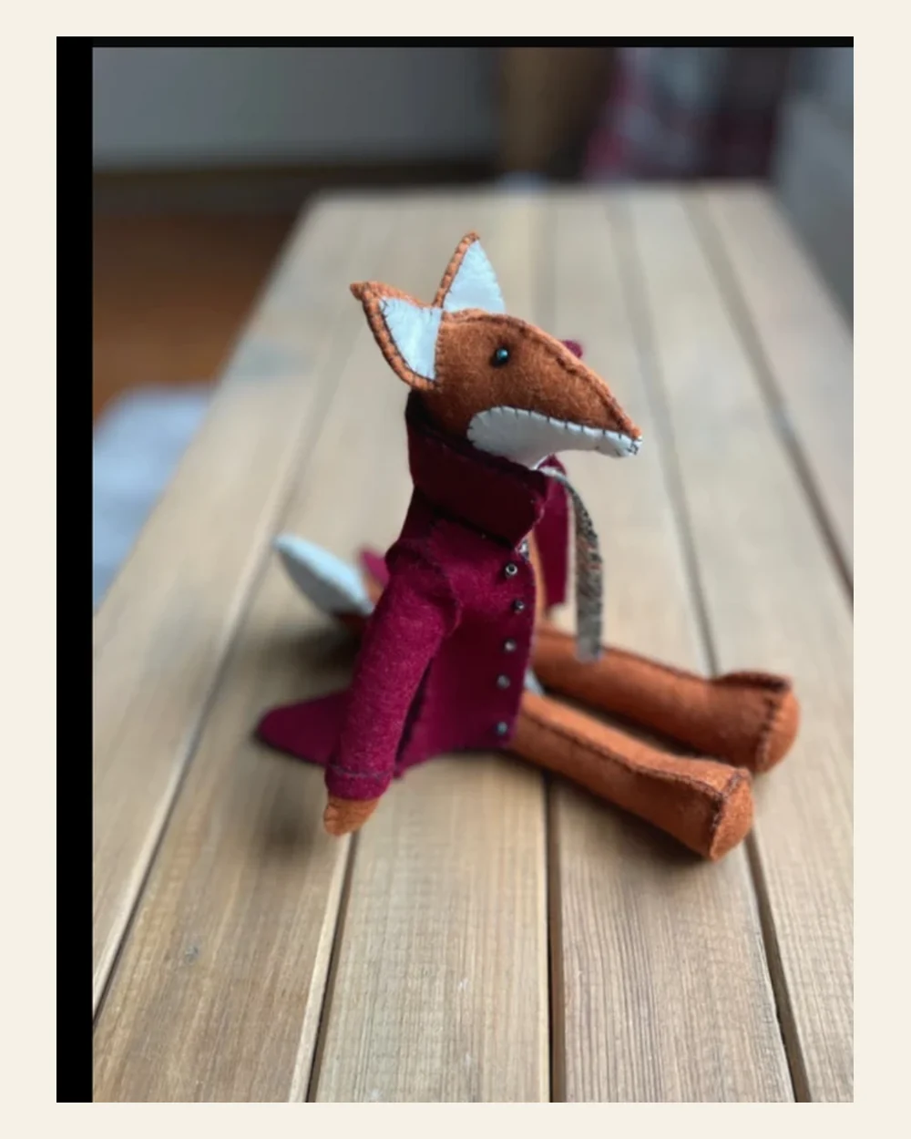 Handmade felt fox wearing a burgundy country coat