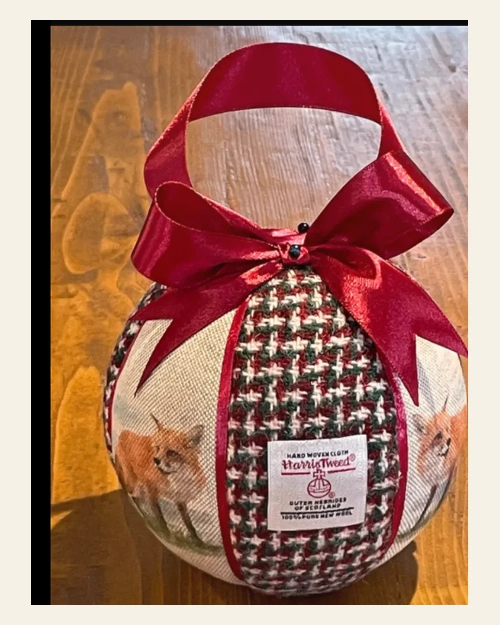 Handmade Harris Tweed Christmas bauble with burgundy ribbon and fox fabric panels